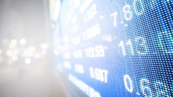 Close-up of tablet newspaper and eyeglasses.