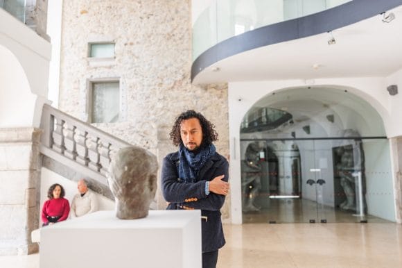 Man looking at a sculpture