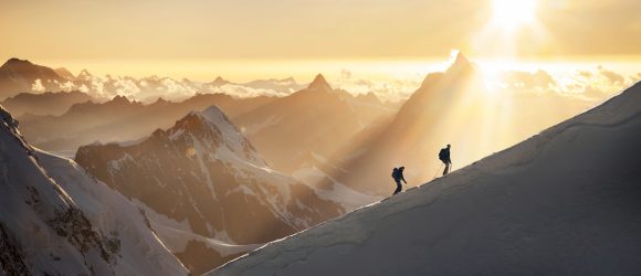 Mountaineers on snowy ridge of Monte Rosa mountain