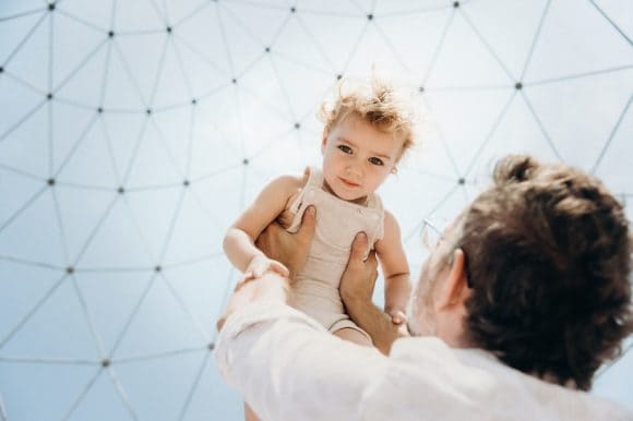 Father holding up child