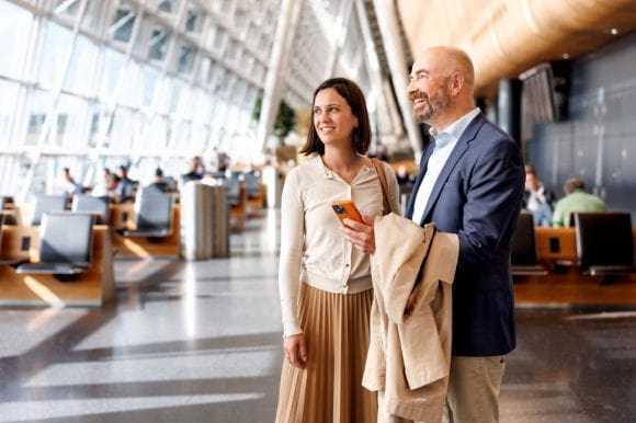 Two business people smiling in airport