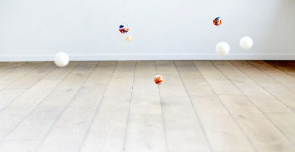 Colorful marbles bouncing on the floor