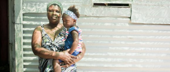 a women of color carrying her daughter