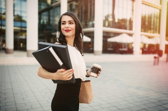 Women holding files and coffee