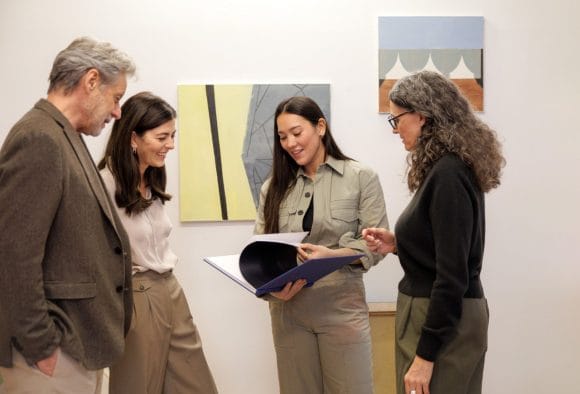 Artist talking to clients in gallery