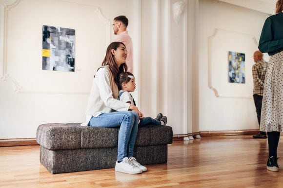 Mother and daughter in art gallery