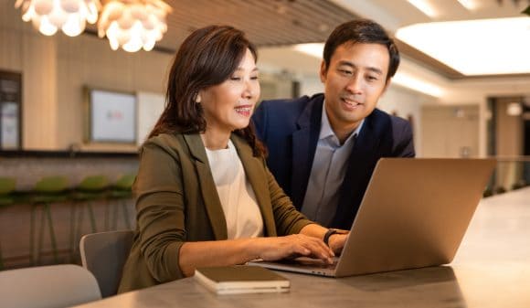 Colleagues working with laptop computer