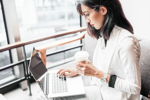 Women with coffee and laptop