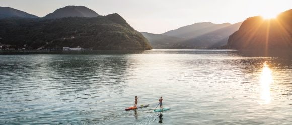 Two paddle boarders on Lake Lugano