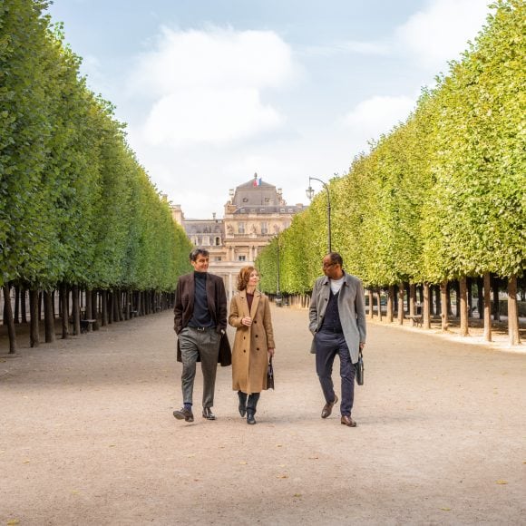 Three people walking down the road