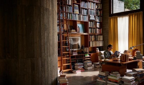 Man reading books in a library