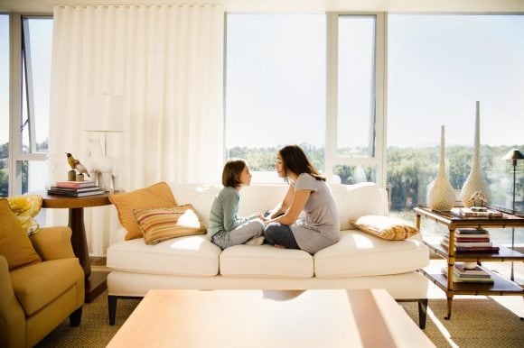 Mother and daughter on a sofa at home