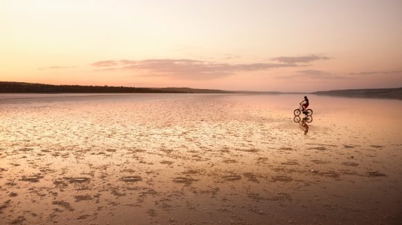 Cyclist in Kuyalnik estuary landscape in Odessa region, Ukraine