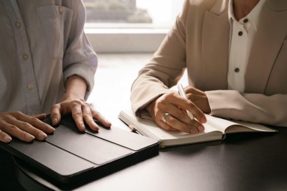 Women with tablet and notebook