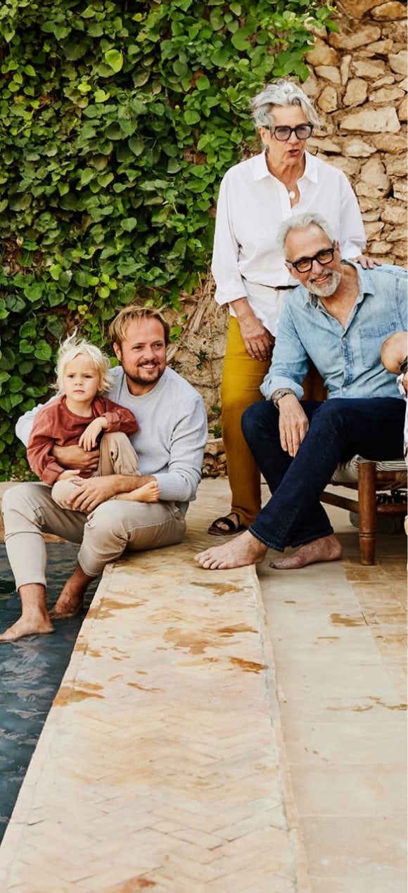 Family sitting by the pool at a gathering