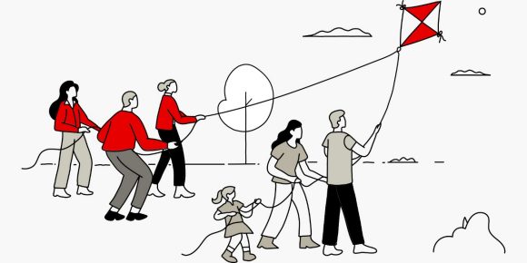 Team helping family with kite