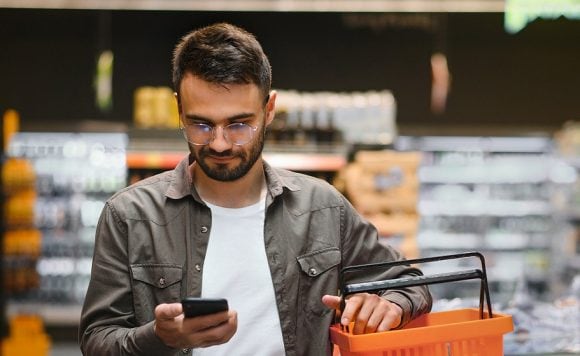 Man in grocery store on cell phone