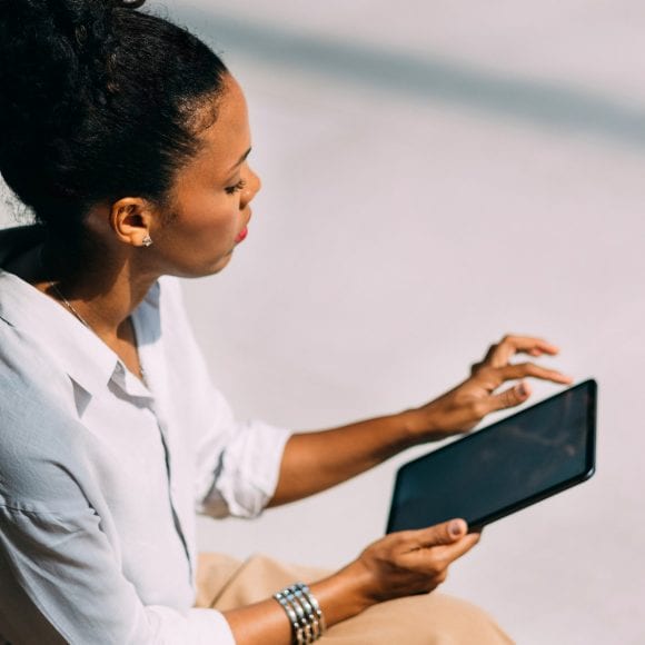 Woman outdoors on tablet