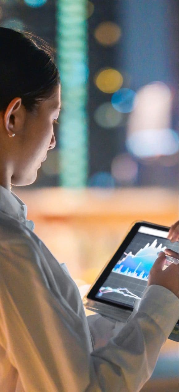 Woman working on a tablet with investments