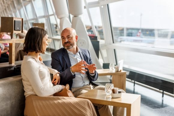 A sitting couple discussing on a boat window
