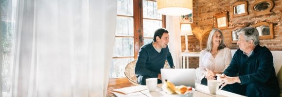 Couple meeting with male Financial Advisor at home