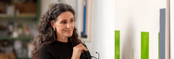 Middle-aged woman smiling in gallery