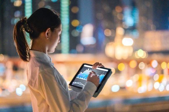 Businesswoman checking financial data on digital tablet