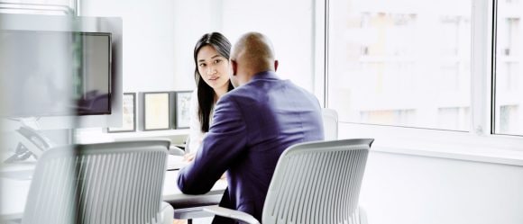 Two people having a business meeting at table