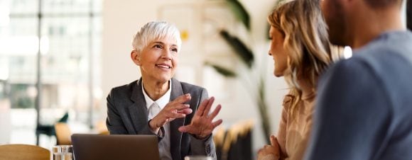 Senior client advisor talking to couple