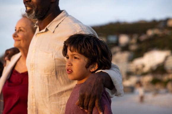 Grandparents with grandson on beach