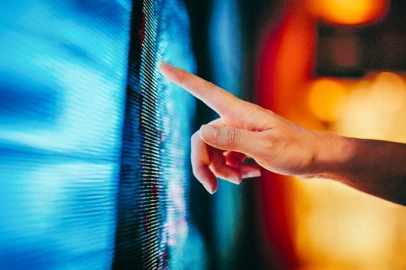 Woman touching LED screen