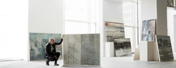 Art dealer examining painting in art gallery