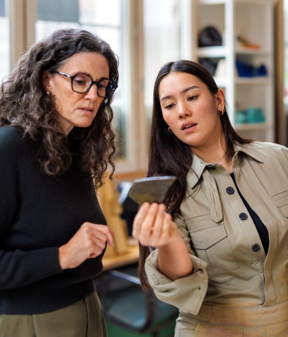 Artist showing shard to client in studio