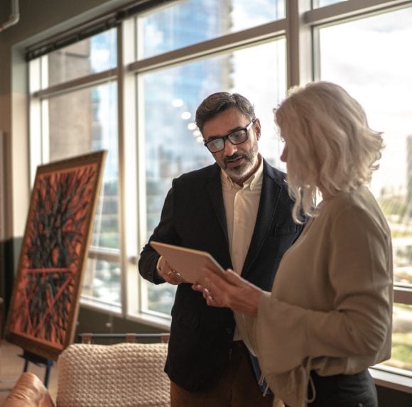 Business partners using digital tablet at office