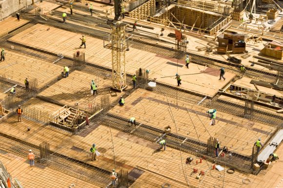 Construction workers working on concrete floor