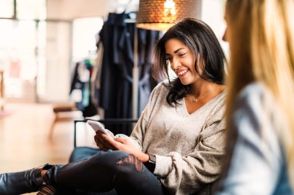 Woman reading message on smartphone