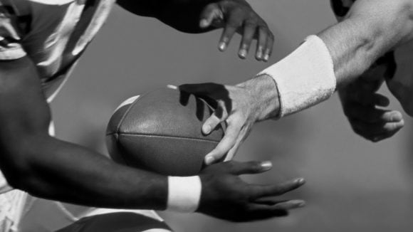 Two foot ball player fight for the ball